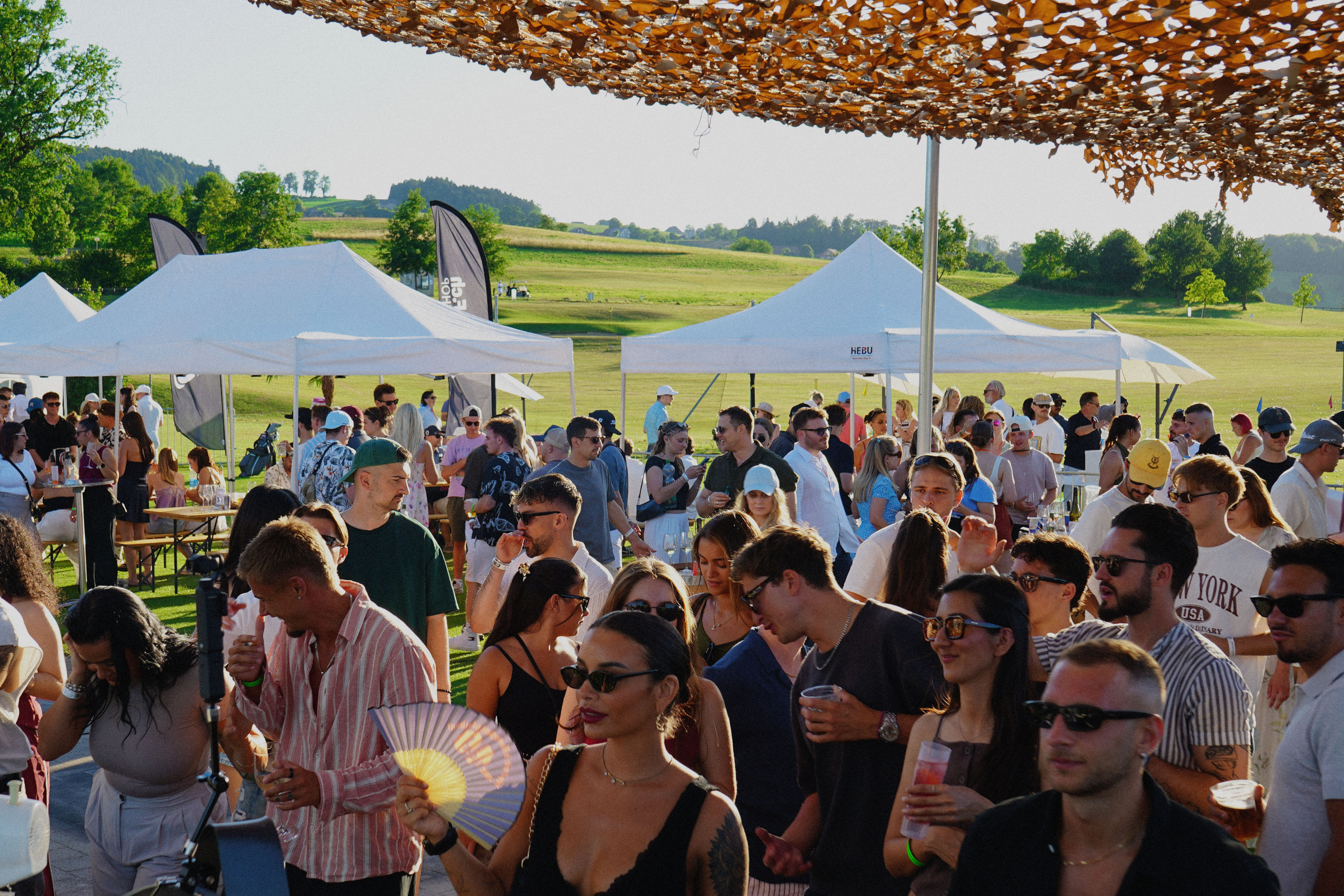 DJ setup on a golf course at sunset